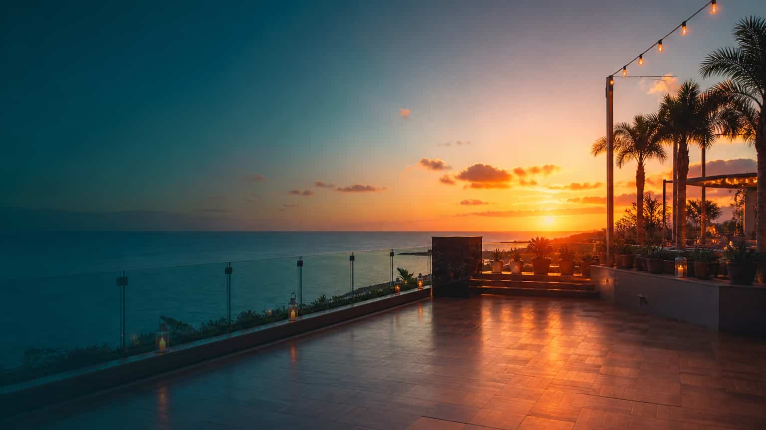 An open-air hotel dance floor overlooking an Atlantic sunset